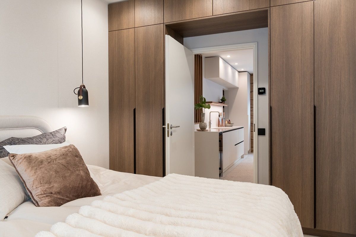 Kantti spotlights with colour temperature control illuminate the front of the bedroom cupboards
